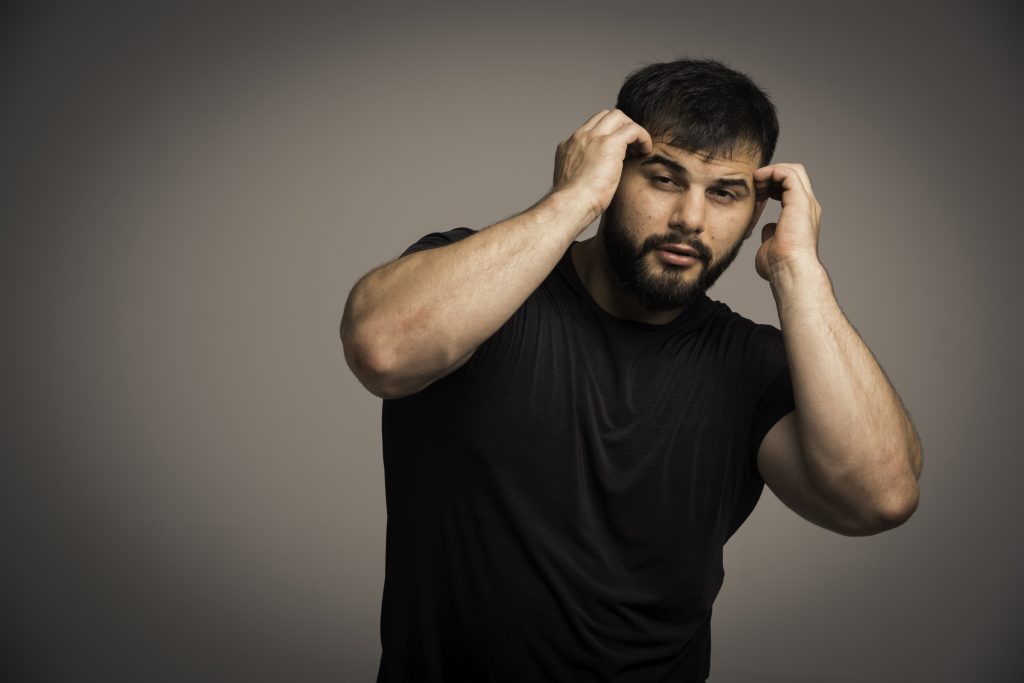 Sportive man in black shirt defends himself. High quality photo